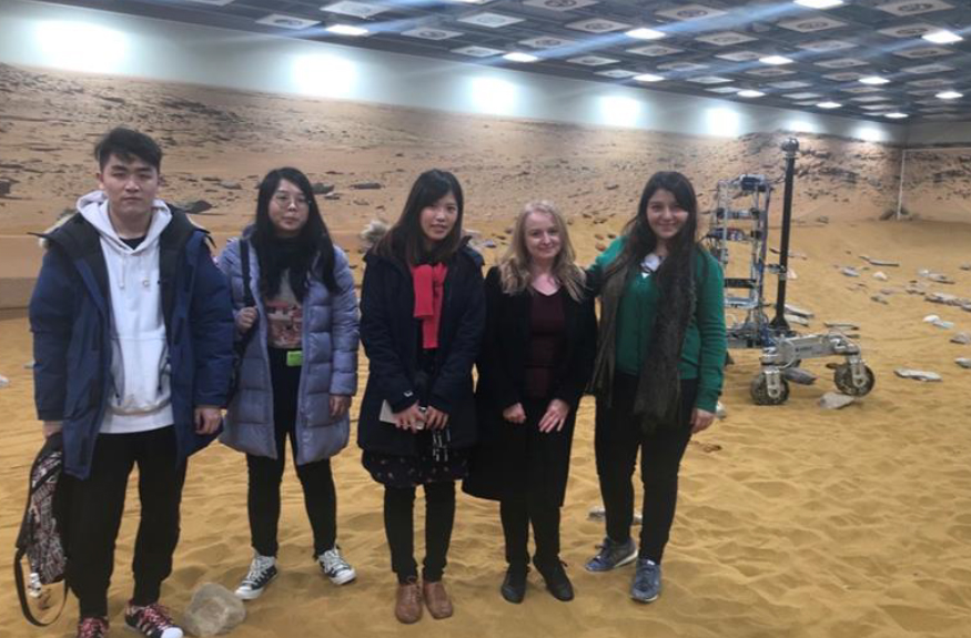 students of the department stand on a martian landscape testing facility