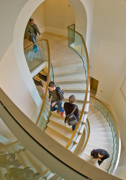 Students using staircase in ӰԺ campus building.